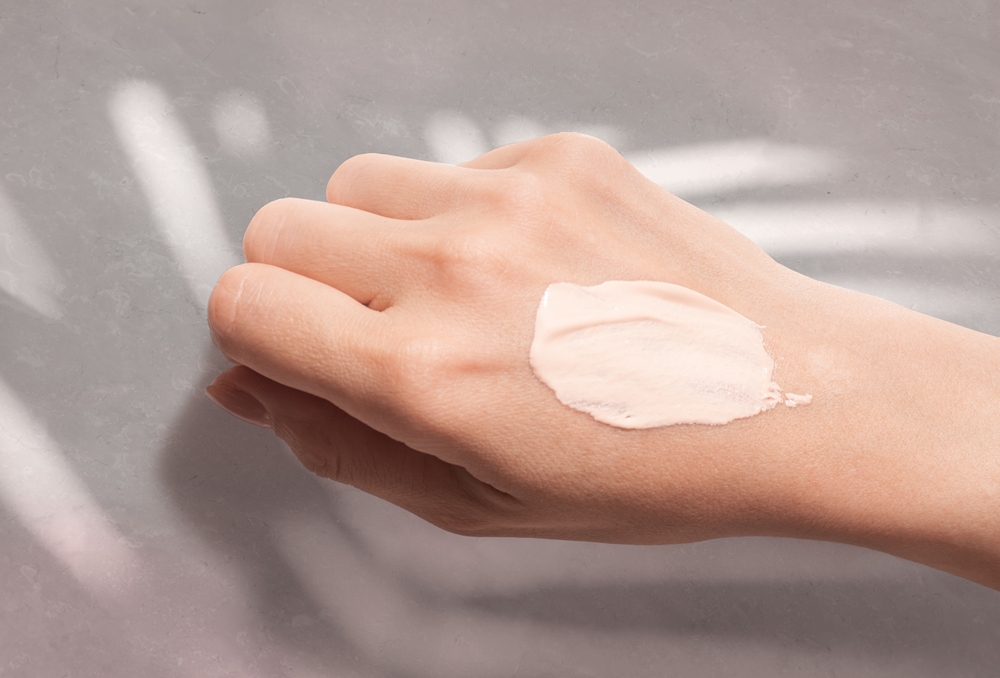 cosmetic,cc,cream,taster,swatch,smudge,on,woman,hand,on