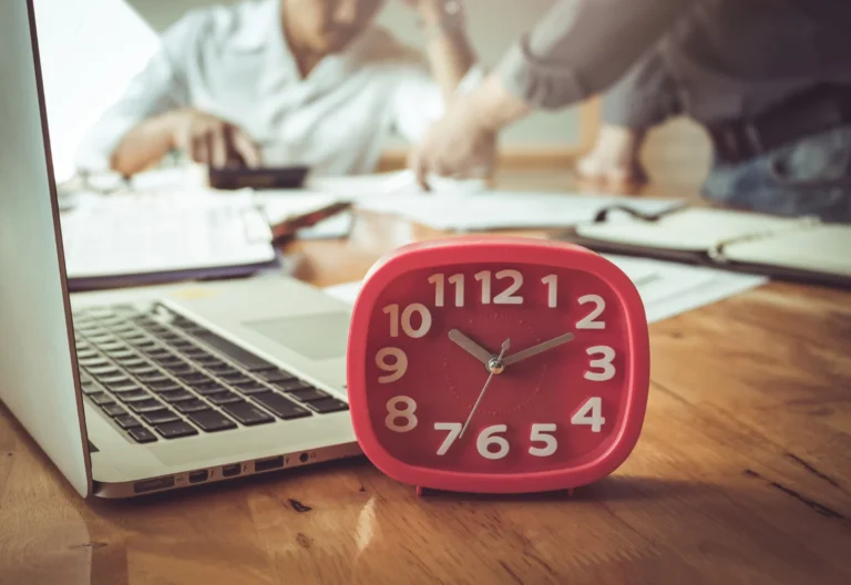 red clock business time wooden desk