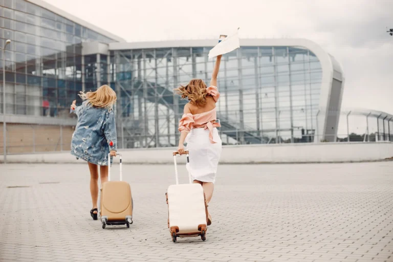 two beautiful girls standing by airport